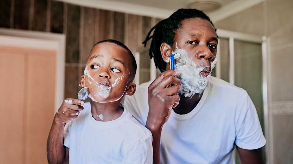 Father and son shaving together